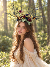 Load image into Gallery viewer, Three-quarter view of the black branch horn headdress with roses and butterflies worn by a model in a cream dress in a forest (AI-generated model image)