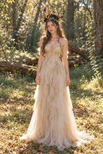 Load image into Gallery viewer, Full-body view of the black branch horn headdress worn by a model in a long cream dress standing in a forest (AI-generated model image)